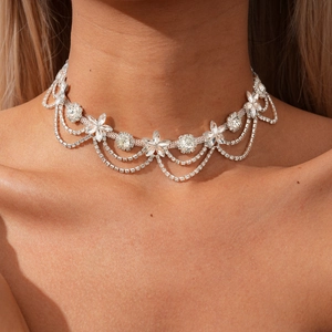 Elegant silver choker with rhinestone flowers and three-layered curved crystal chains