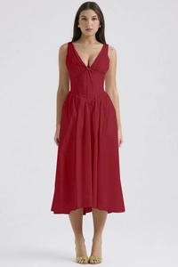 Detailed view of the deep V-neckline and corset waist on a red sleeveless midi dress