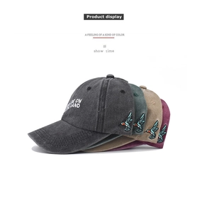 Detailed embroidery of hummingbirds on vintage washed cotton baseball caps in four colors