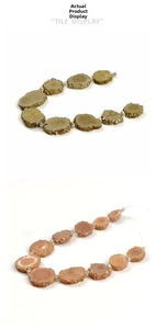 Flat lay of irregular druzy stone beads in gold and pink for jewelry making