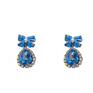 Elegant blue crystal bowknot drop earrings with sparkling rhinestones in a studio shot