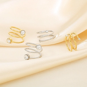 Detail view of multi-layer spiral rings in gold and silver finish with sparkling stones