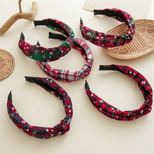 Detail of Christmas plaid knot headbands featuring snowflake patterns in festive colors