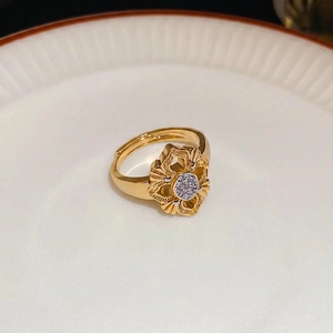 24K gold plated flower ring with radiating textures and center crystal in retro style