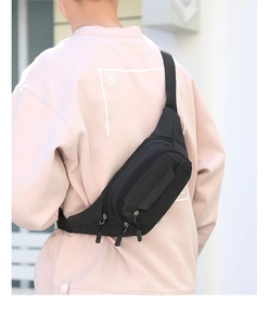 Close-up of black nylon sports waist bag with adjustable strap and buckle for outdoor travel