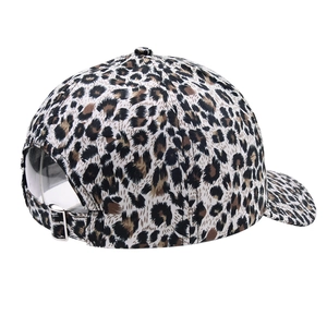 Detail of leopard print baseball cap featuring an adjustable metal buckle and cotton texture
