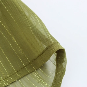 Close-up of green chiffon blouse fabric with golden pinstripes and detailed stitching
