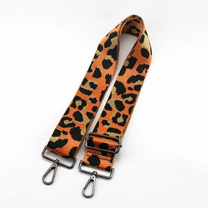 Close-up of adjustable leopard print bag strap with gunmetal swivel hooks and metal buckle