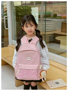 Pink fabric school backpack featuring a cute white cat print and bread-shaped charm detail