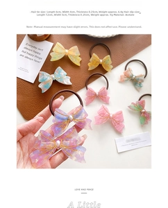 Detail of marble pattern acetate bow hair clip and tie with pearl decoration