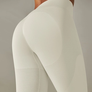 Detailed close-up of seamless beige yoga pants showing breathable knit fabric texture