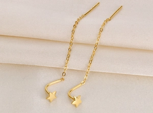 Macro view of gold S925 sterling silver star and moon tassel drop thread earrings