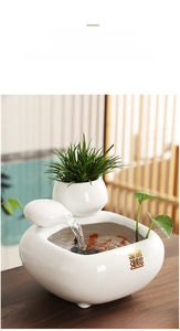 Detailed view of white ceramic flowing water fountain with gold Fortune characters
