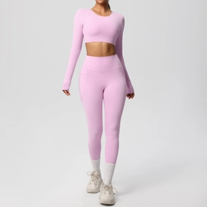 Detail of high-waist pink yoga leggings featuring practical side pockets and elastic fabric