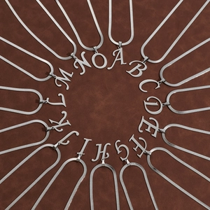 Hip hop style silver alphabet letter pendants A-O on snake chains arranged in a circular layout