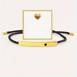 Close-up of woven bracelet with gold-tone metal plate featuring Just Breathe engraving