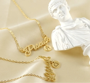 Close-up of gold 18k plated zodiac necklaces featuring Pisces and Libra pendants on silk
