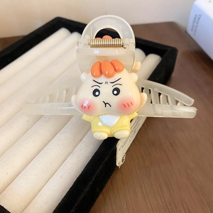 Close-up of cute cartoon acrylic hair claw clip with cream translucent finish and figure