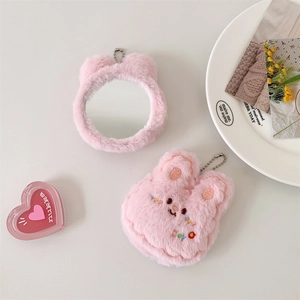 Detail of pink plush bunny pocket mirror keychain with soft embroidery and metal chain