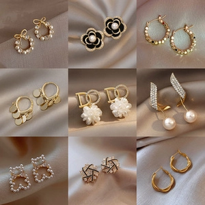 Detailed grid showing gold pearl earrings with camellia, bow, and bear motifs