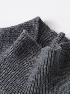Close-up of premium grey rib-knit fabric texture on a soft stand-up collar sweater