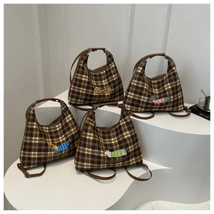 Detail view of four plaid tote bags featuring cute dachshund embroidery and leather straps