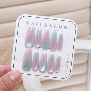 Detailed view of pink and blue gradient cat-eye coffin nails on a display board