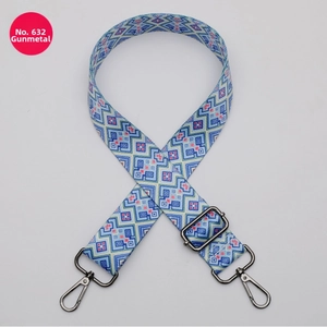 Adjustable wide fabric strap with blue geometric ethnic pattern and gunmetal hardware