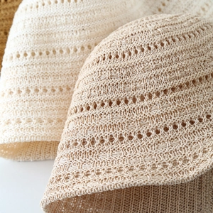 Detail of hollow woven knit pattern on beige and coffee sun hats with breathable texture