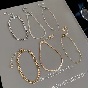 Three-piece gold and silver snake chain bracelet set with minimalist metal curb links