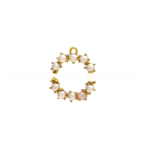 Detail of a round pearl pendant with pink accent set in a golden metal base