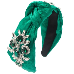 Detail of green chiffon headband with emerald rhinestones and twisted knot design