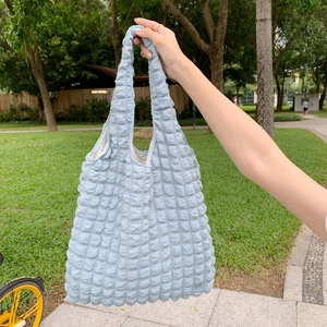 Detail shot of light blue bubble textured tote bag with unique 3D polyester fabric