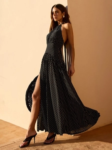 Elegant black polka dot halter maxi dress with backless design and high side slit