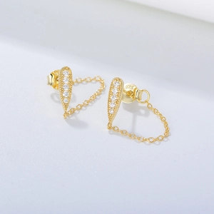 Close-up of golden S925 silver teardrop earrings with white zircon and chain fringe