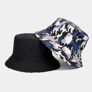 Close-up of camouflage and black reversible bucket hats with reinforced brim stitching
