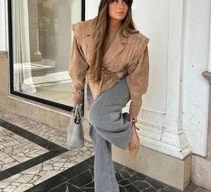 Détail de la veste en daim camel avec épaules plissées et ceinture assortie