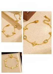 Detail of gold chain bracelet with star charms and oval crystal stones showing the clasp