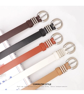 Multiple colors of faux leather belts with silver buckles on white background
