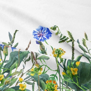 Close-up of bohemian fabric tapestry with watercolor cornflowers and leaf print patterns