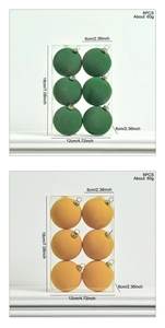 Detail showing 6cm flocked Christmas balls in green and orange with size and weight specs