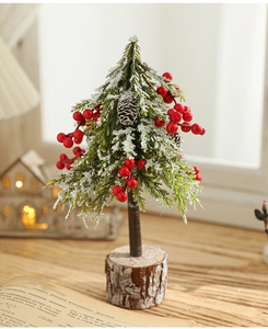 Detail of mini snowy Christmas tree with red berries and pine cone on a wooden base