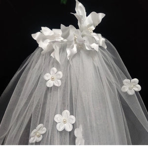 Short white bridal veil with 3D flowers and pearls against a dark background