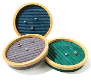 Macro detail of round bamboo jewelry display trays with colorful velvet ring slots