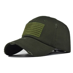 Detail of army green washed cotton baseball cap with American flag tactical patch and frayed brim