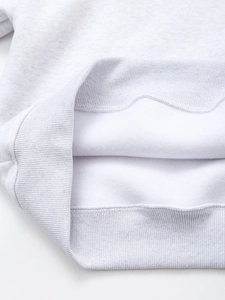 Detail view of the light grey sweatshirt ribbed hem and thick thermal fleece lining