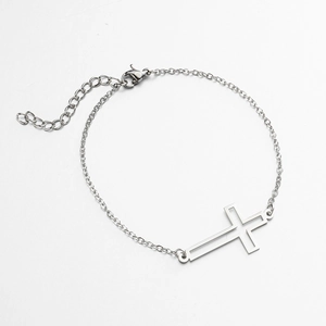 Detailed shot of silver cross pendant bracelet with adjustable link chain and lobster clasp