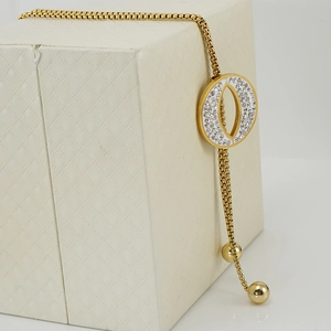 Golden tassel sweater necklace with adjustable slider and rhinestone oval pendant