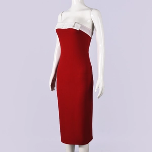 Detail of red tube top dress with contrast white bow on a textured knit fabric
