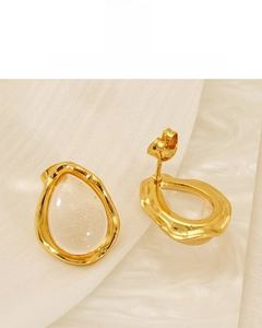 Macro shot of 18K gold plated teardrop stud earrings with transparent resin drop